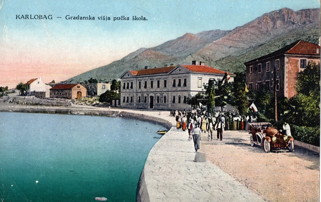 The old harbor and civic school in Karlobag, circa 1910